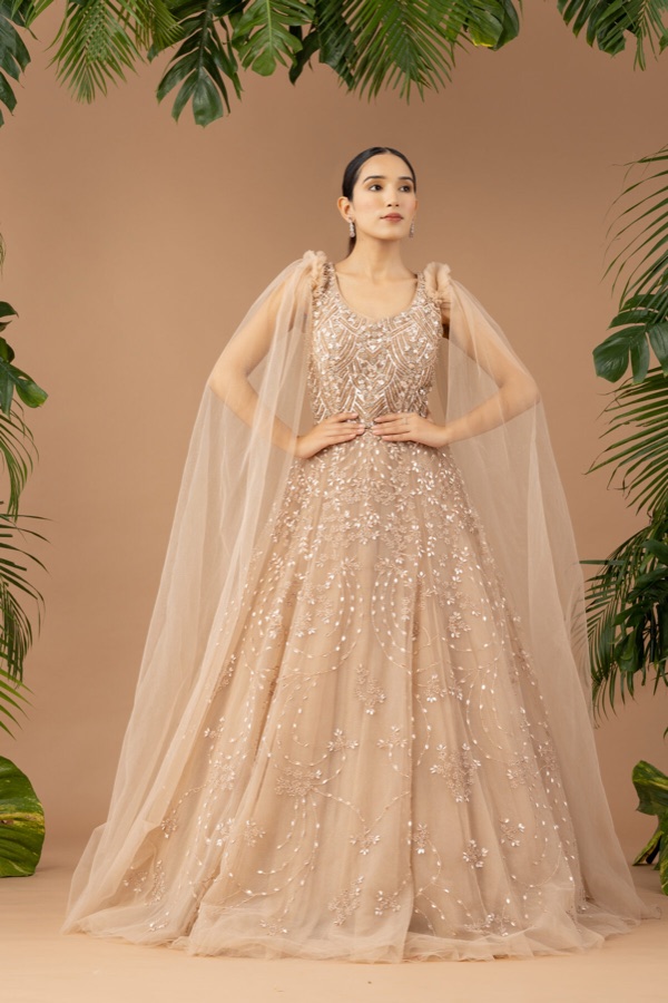 Cream tulle gown with sheer cape sleeves