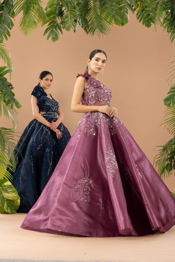 Two models in navy and magenta ball gowns