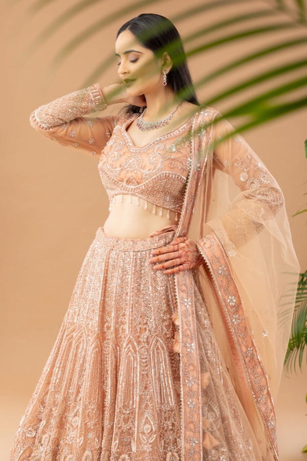 Motion profile portrait in a peach lehenga