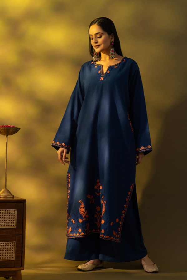 Navy embroidered kurta under dramatic lighting