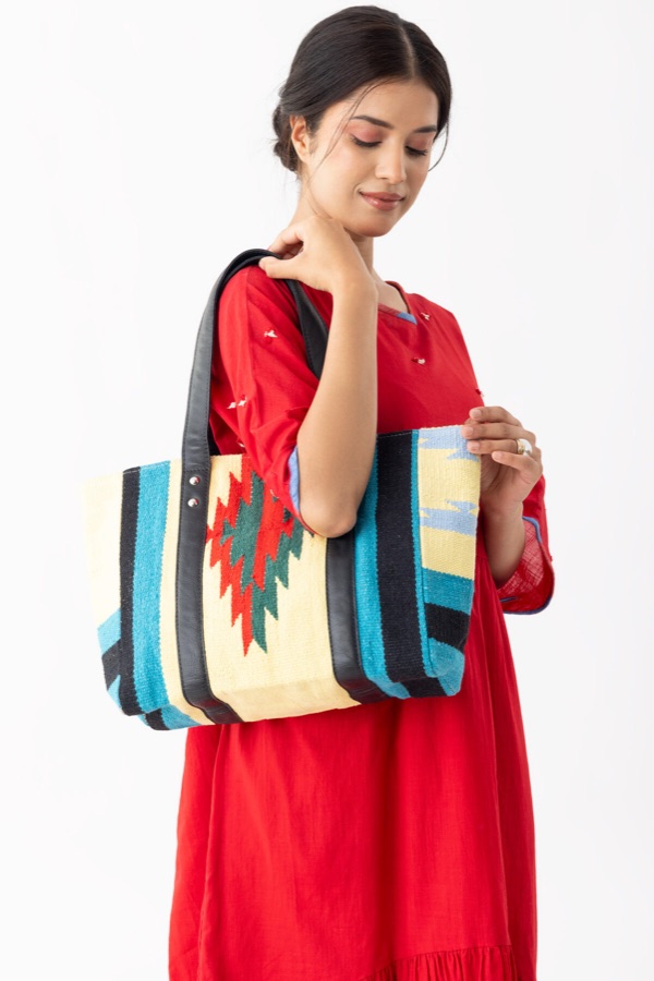 Red dress styled with a handwoven tote bag