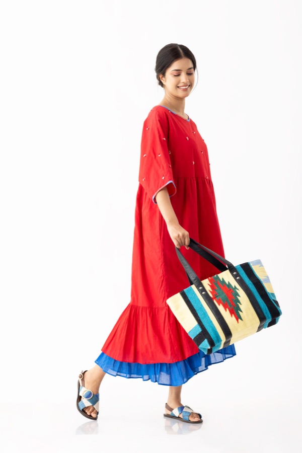 Red dress and handwoven tote, in motion